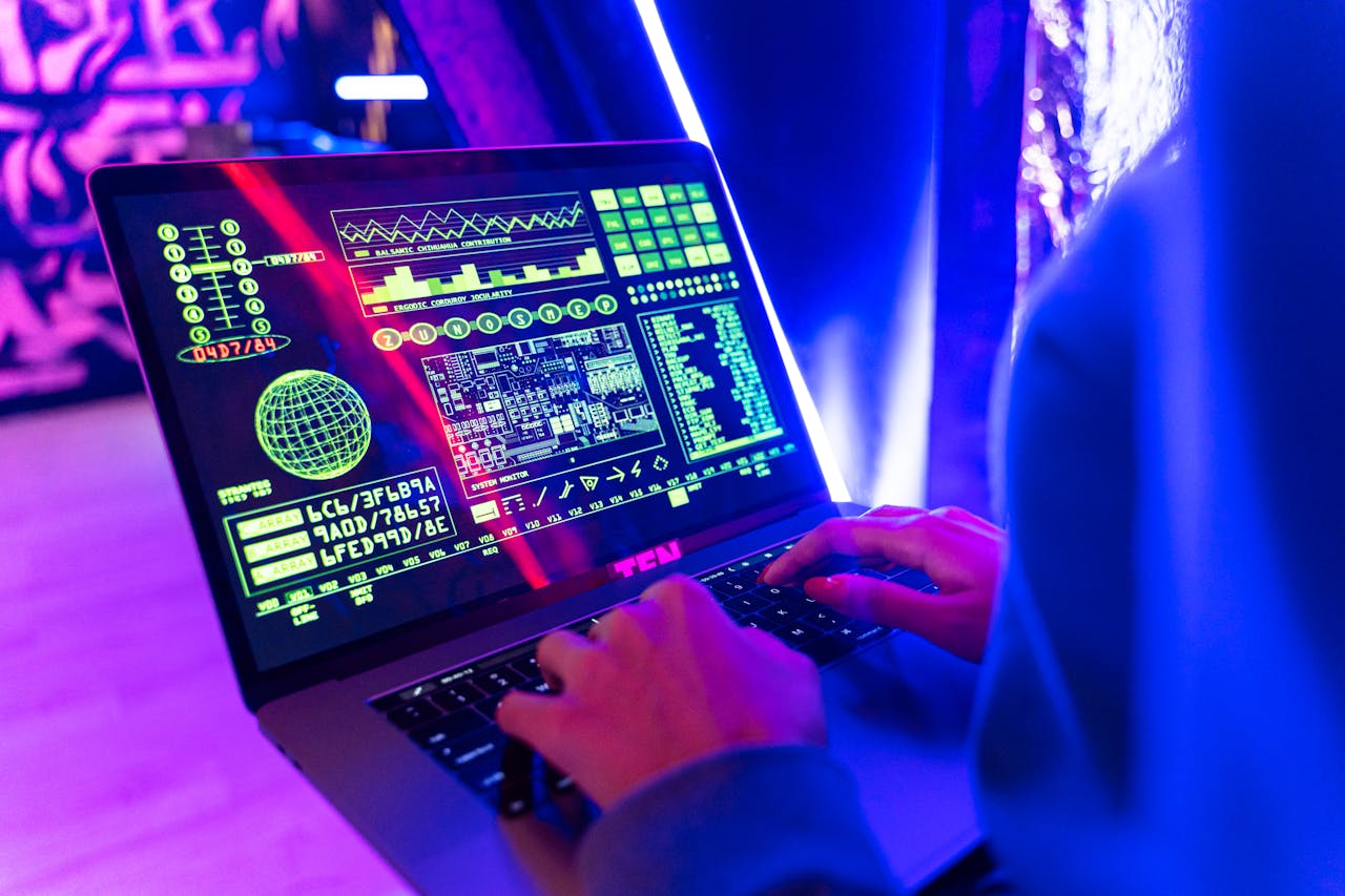 About Person typing on a laptop with vibrant digital data display, highlighting cyber security.